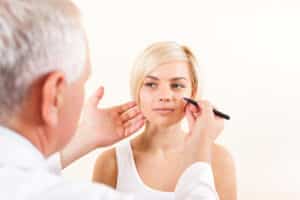 male doctor consulting a female patient about her facial plastic procedure